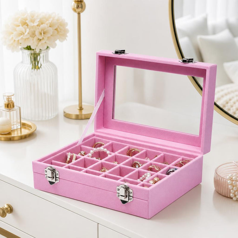Velvet jewelry box with glass lid and compartments on a vanity
