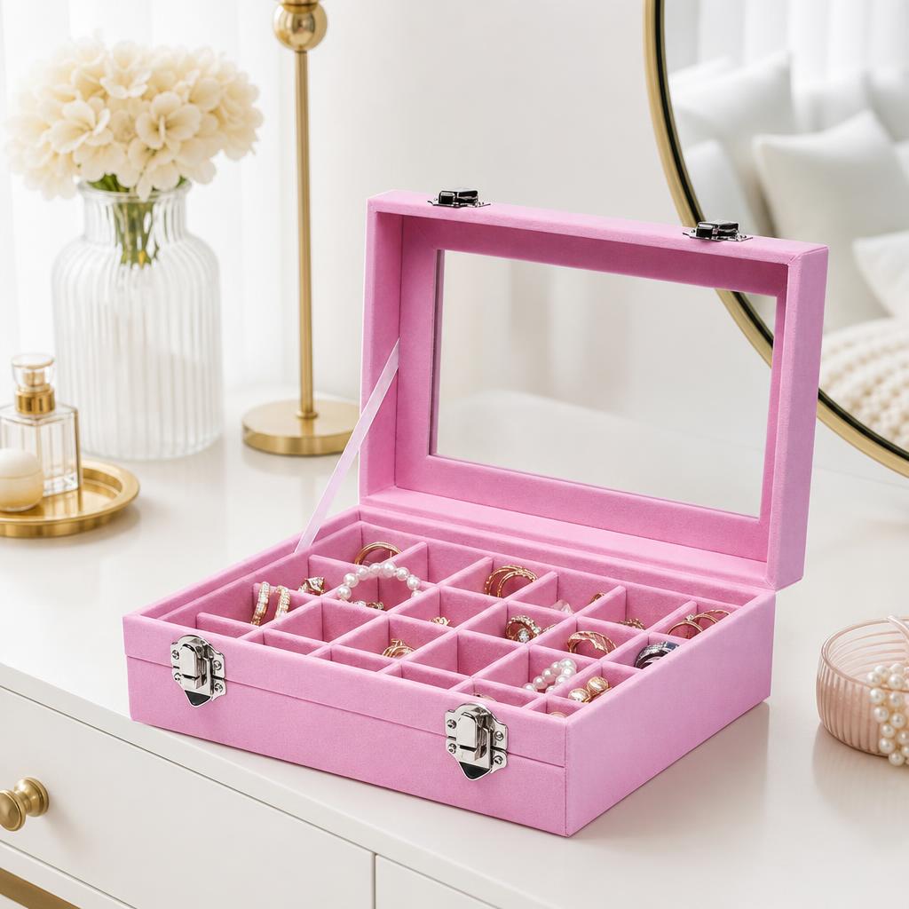 Velvet jewelry box with glass lid and compartments on a vanity